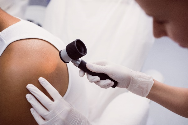A Man Reducing His Risk Of Skin Cancer Through Examination