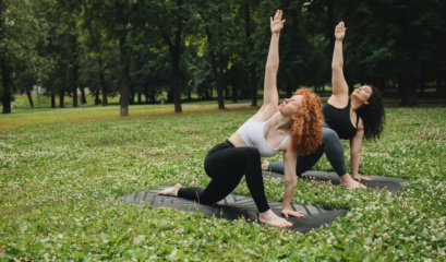 Two women performing yoga asana outdoors promoting women’s health and weight management