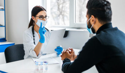 A Female Doctor Consults Her Patient And Holds Documents In Her