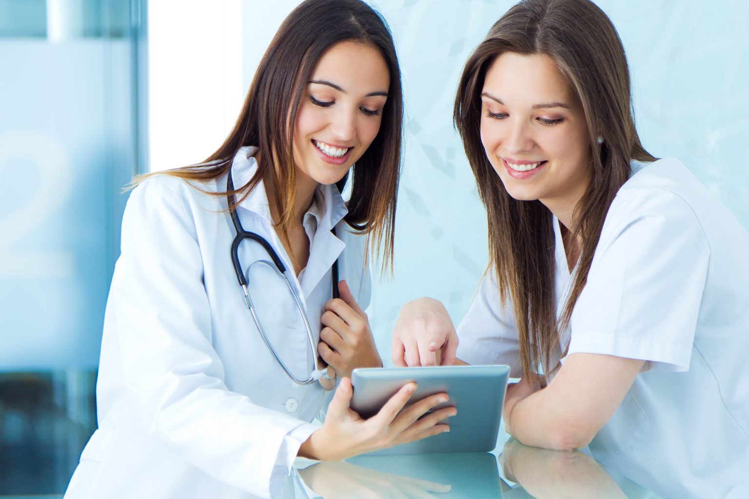Medical And Nurse Looking For Something On A Digital Tablet