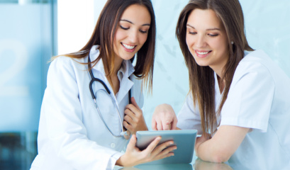 Medical And Nurse Looking For Something On A Digital Tablet