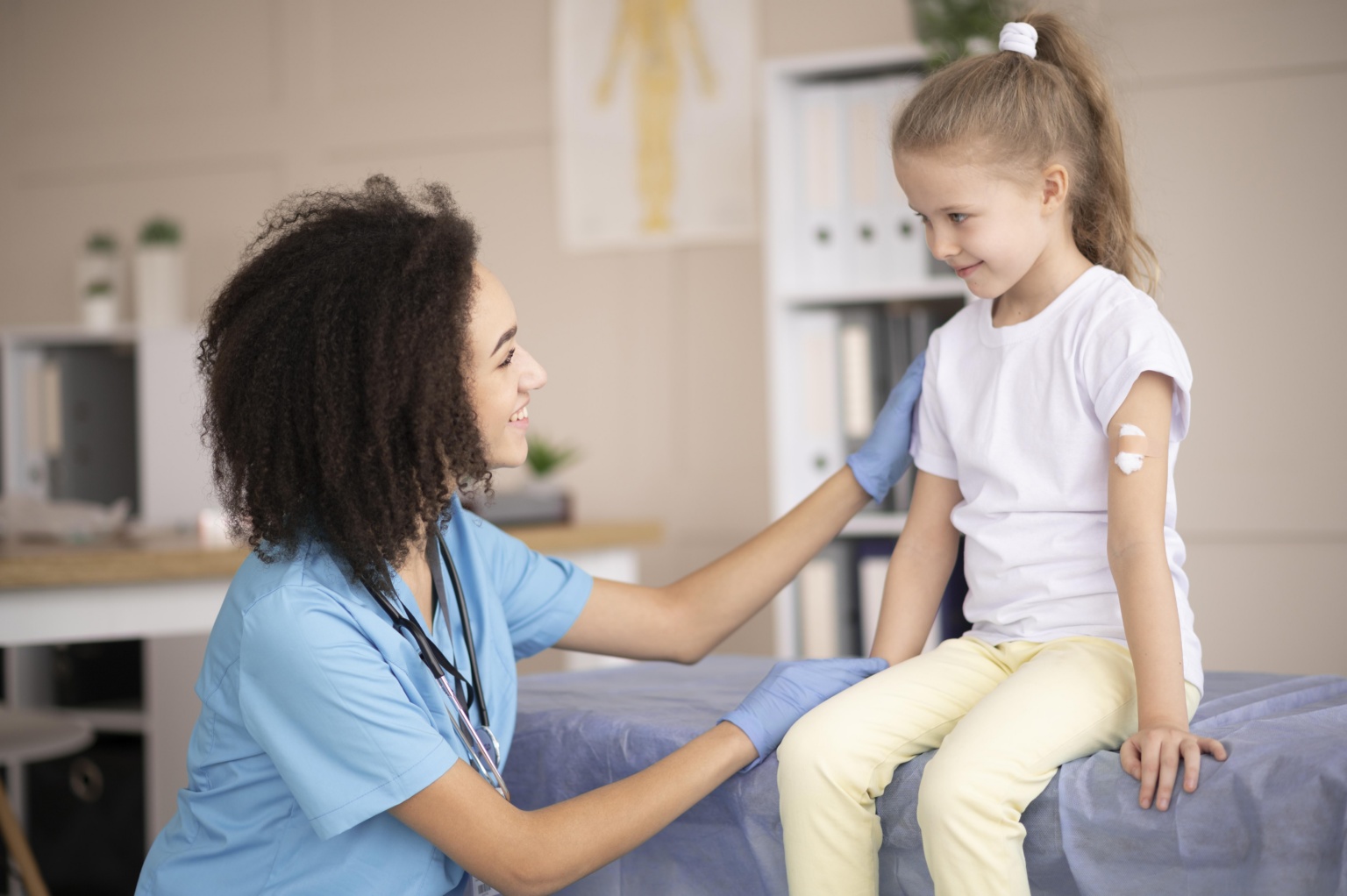 Young Doctor Making Sure Little Girl Is Fine After Vaccination